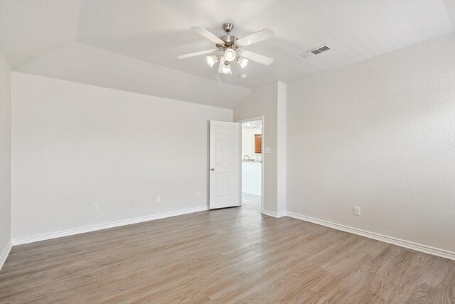 unfurnished room featuring vaulted ceiling, light hardwood / wood-style flooring, and ceiling fan