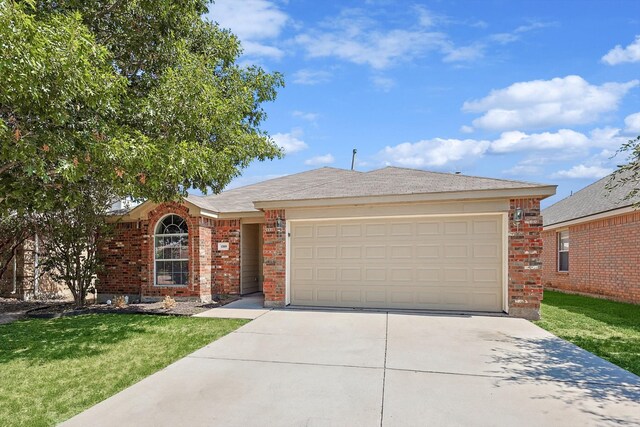 ranch-style home featuring a garage and a front lawn