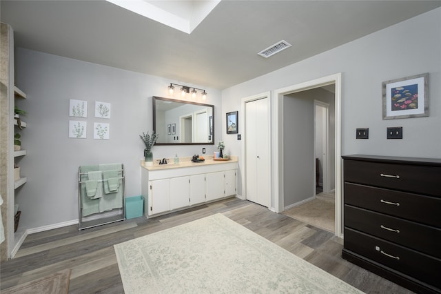 bathroom with hardwood / wood-style floors and vanity