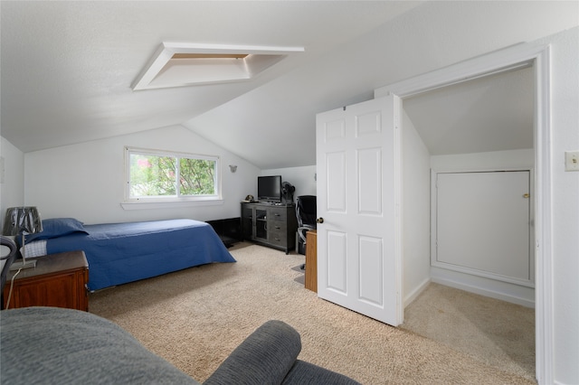 bedroom featuring light carpet and lofted ceiling