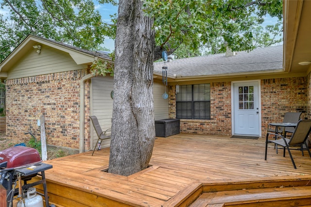 wooden deck featuring a grill