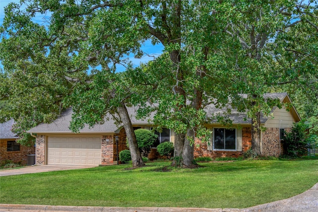 view of front of home with a front yard and a garage