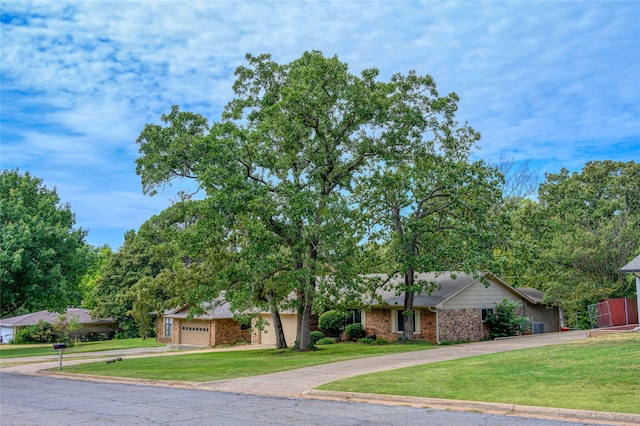 view of front of home featuring a garage and a front lawn