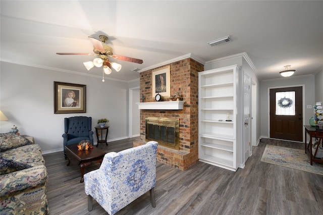 living room featuring dark hardwood / wood-style floors, ceiling fan, ornamental molding, and a brick fireplace