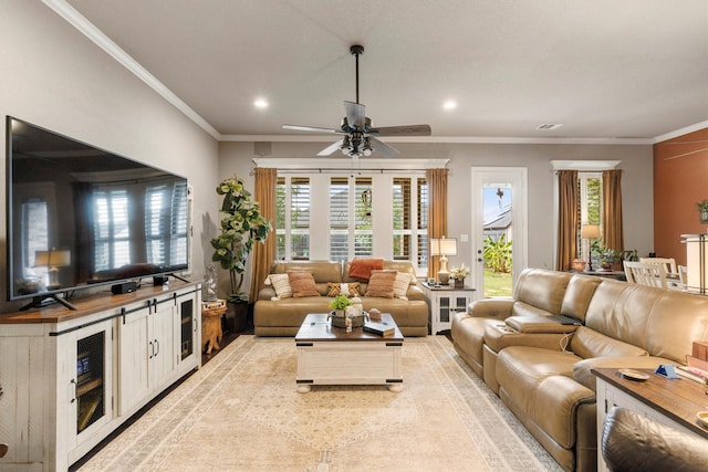 living room with ornamental molding and ceiling fan