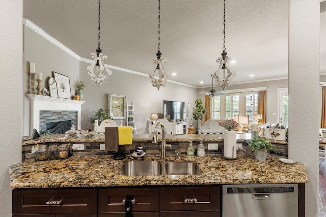 kitchen with dishwasher, a fireplace, crown molding, stone countertops, and sink