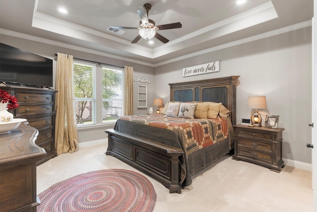 carpeted bedroom featuring ceiling fan, a raised ceiling, and crown molding