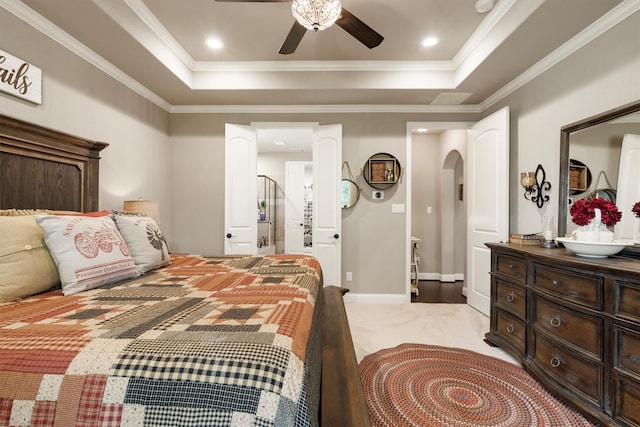 bedroom with crown molding, a raised ceiling, light colored carpet, and ceiling fan