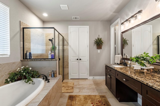 bathroom with vanity and separate shower and tub