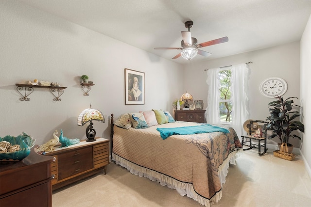 bedroom with light carpet and ceiling fan