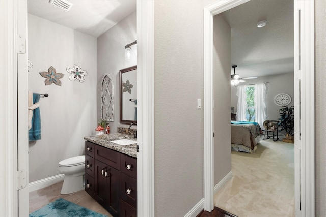 bathroom featuring vanity, toilet, and ceiling fan