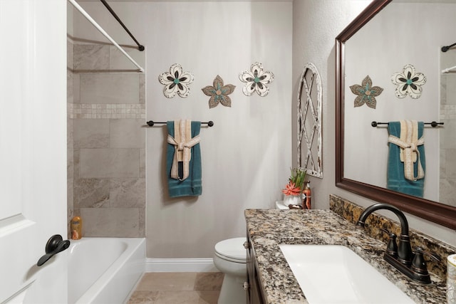 full bathroom featuring tile patterned flooring, toilet, tiled shower / bath, and vanity