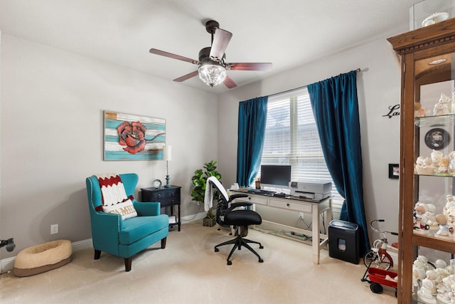 carpeted office space featuring ceiling fan