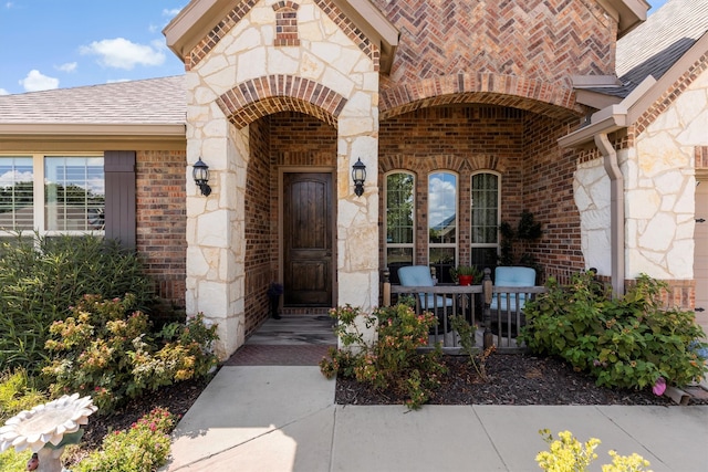 view of exterior entry with covered porch