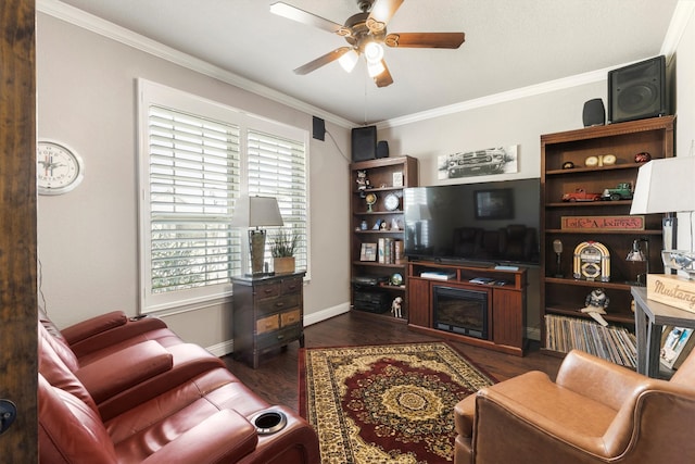 living room featuring dark wood-type flooring, ceiling fan, a wealth of natural light, and ornamental molding