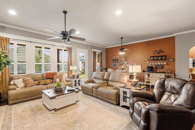 living room featuring crown molding and ceiling fan