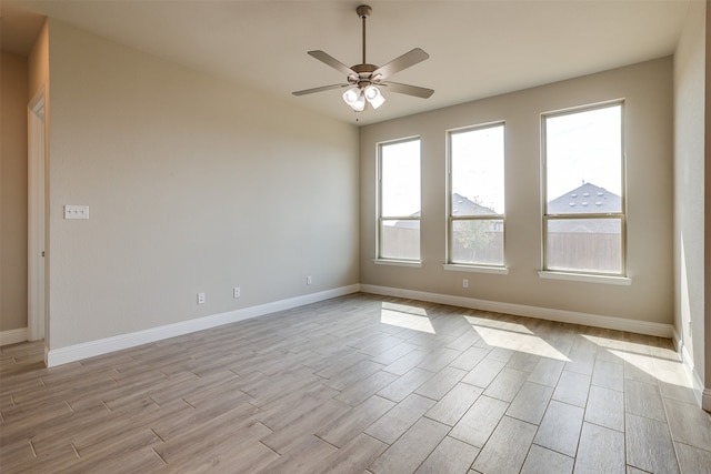 unfurnished room featuring light hardwood / wood-style flooring and ceiling fan