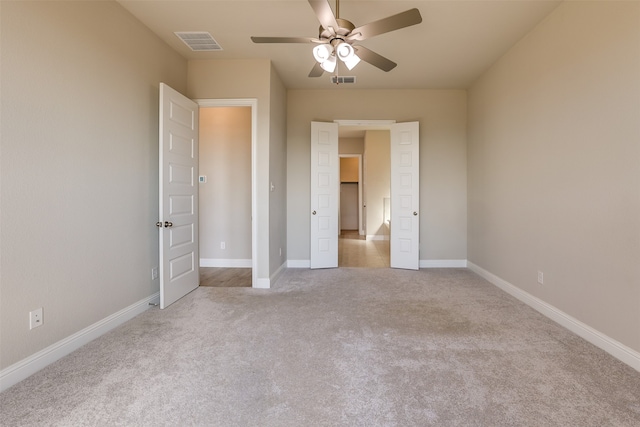 unfurnished bedroom with light carpet and ceiling fan