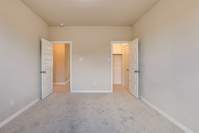 unfurnished bedroom with light carpet