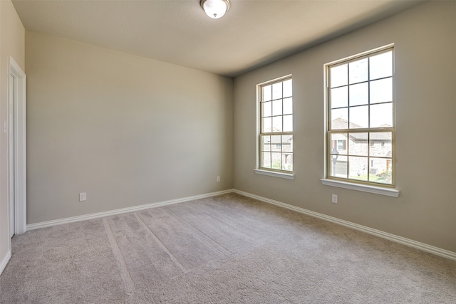 spare room featuring light colored carpet