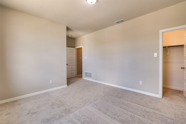 spare room featuring light colored carpet