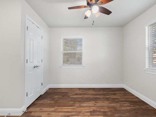 spare room featuring ceiling fan and dark hardwood / wood-style flooring