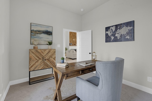 home office with baseboards and carpet flooring