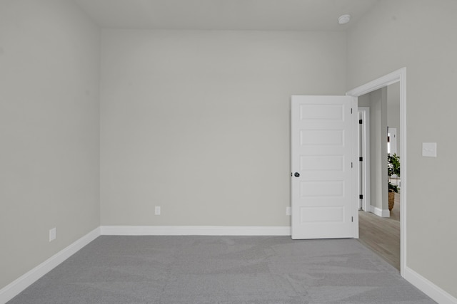 unfurnished room with light colored carpet