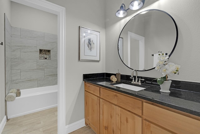 bathroom featuring shower / tub combination, vanity, and baseboards