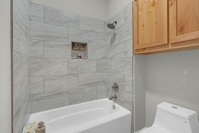 bathroom with toilet and tiled shower / bath combo