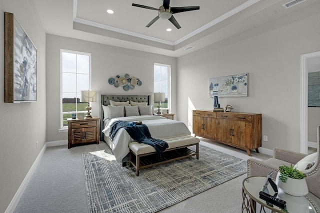 bedroom featuring visible vents, baseboards, and a raised ceiling