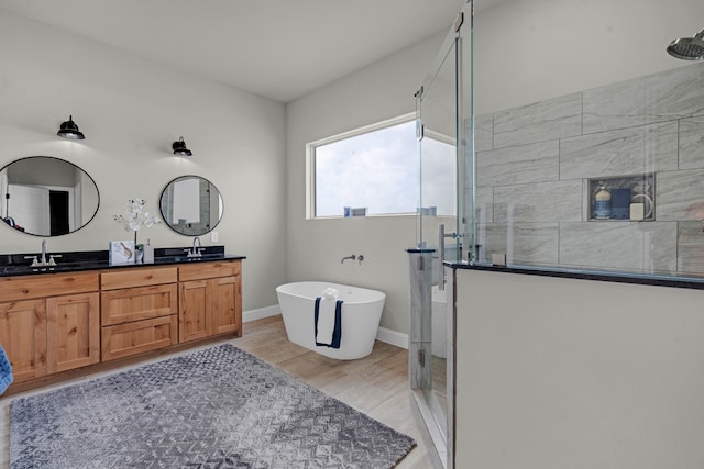 bathroom with shower with separate bathtub, hardwood / wood-style floors, and vanity