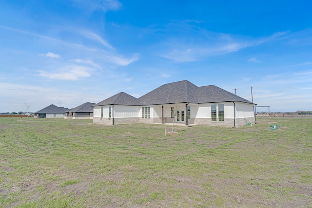 back of property featuring a lawn