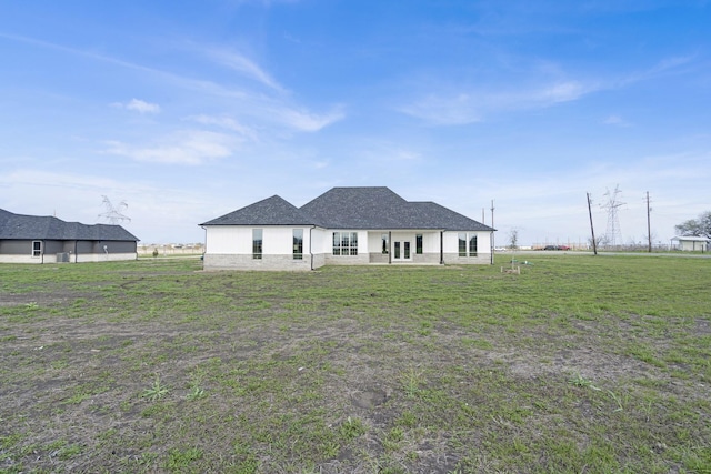 back of property featuring a lawn