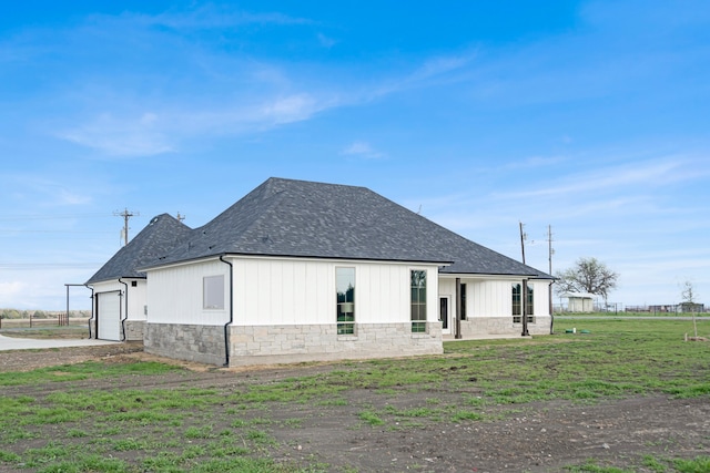 rear view of property featuring a lawn