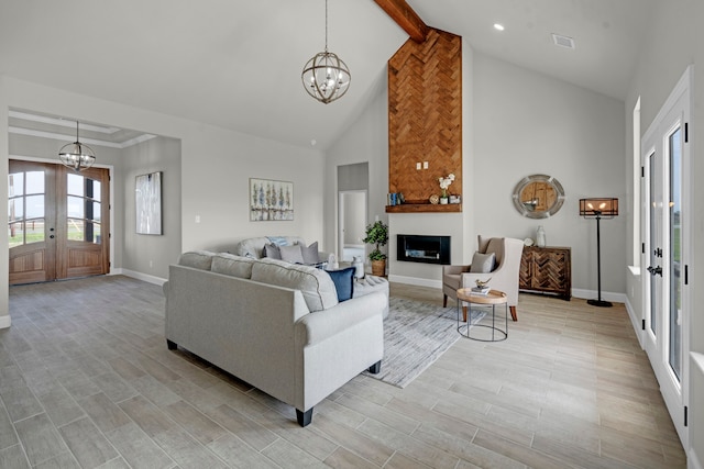 living room featuring beamed ceiling, high vaulted ceiling, a notable chandelier, light hardwood / wood-style flooring, and french doors