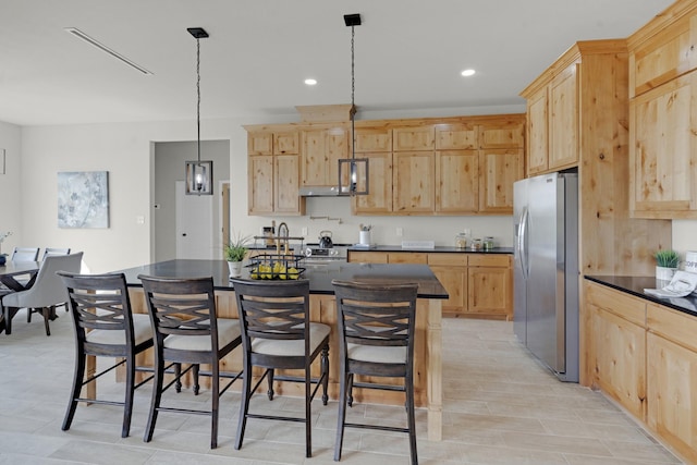 kitchen featuring dark countertops, a breakfast bar, stainless steel refrigerator with ice dispenser, and light brown cabinetry