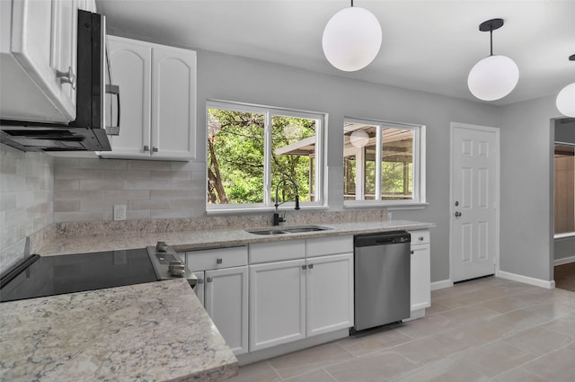 kitchen with appliances with stainless steel finishes, tasteful backsplash, white cabinets, decorative light fixtures, and sink