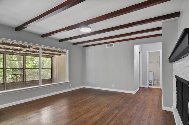 unfurnished living room featuring a fireplace, dark hardwood / wood-style floors, and beamed ceiling