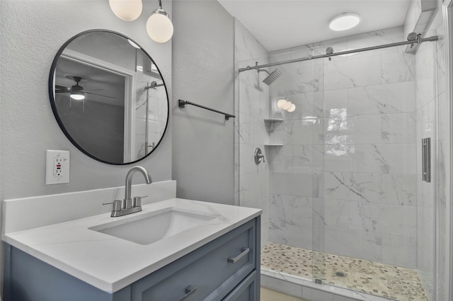 bathroom featuring vanity, ceiling fan, and an enclosed shower