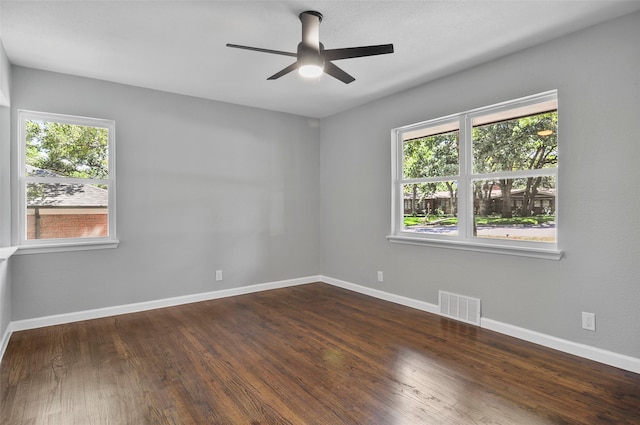 unfurnished room featuring ceiling fan and dark hardwood / wood-style flooring