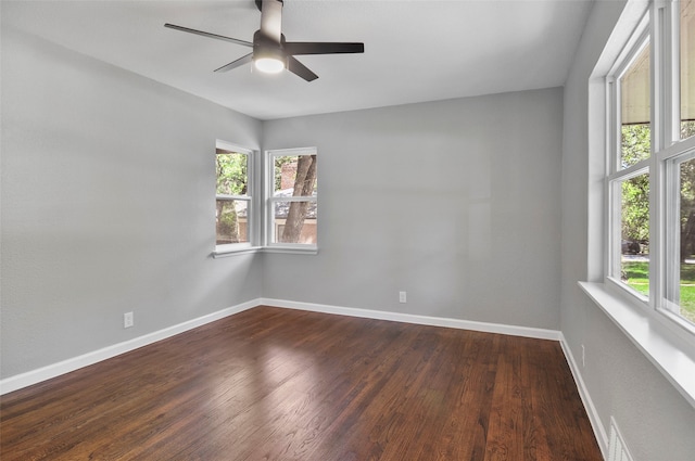 spare room with ceiling fan and dark wood-type flooring