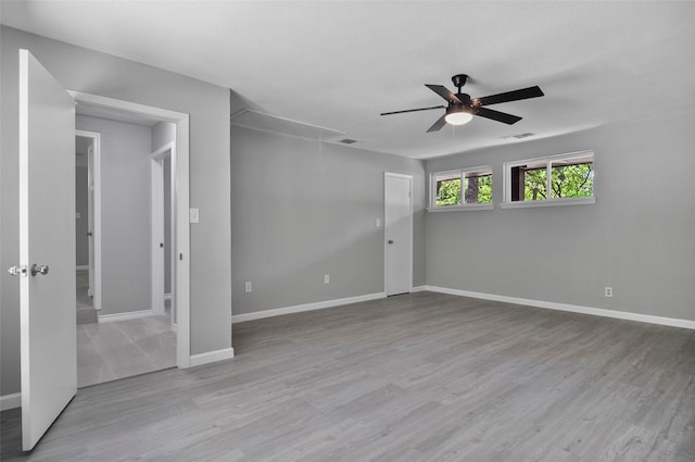 spare room featuring light hardwood / wood-style floors and ceiling fan