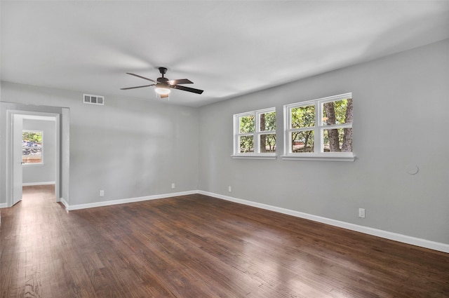 spare room with ceiling fan and dark hardwood / wood-style floors