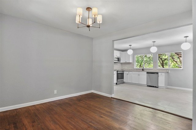 interior space with a chandelier and hardwood / wood-style flooring