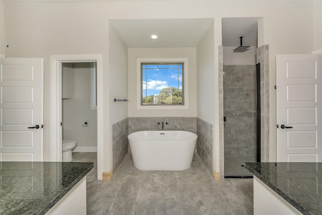 3043 Sunrise Trl, Weatherford, TX 76088 - full bathroom with toilet, a tile shower, tile walls, a freestanding bath, and vanity