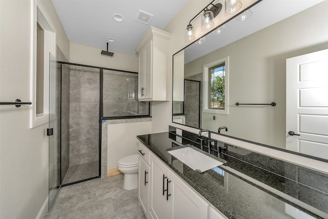 bathroom with a shower with shower door, toilet, and vanity