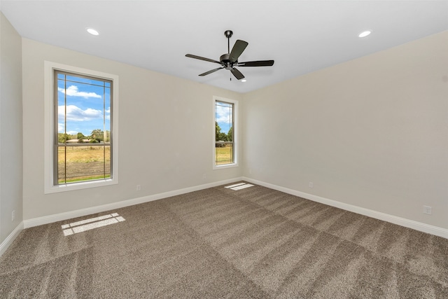 empty room featuring carpet flooring and ceiling fan