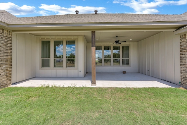 back of property featuring ceiling fan, a lawn, and a patio