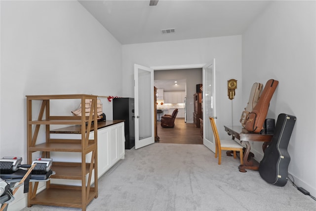 hallway featuring light colored carpet and french doors